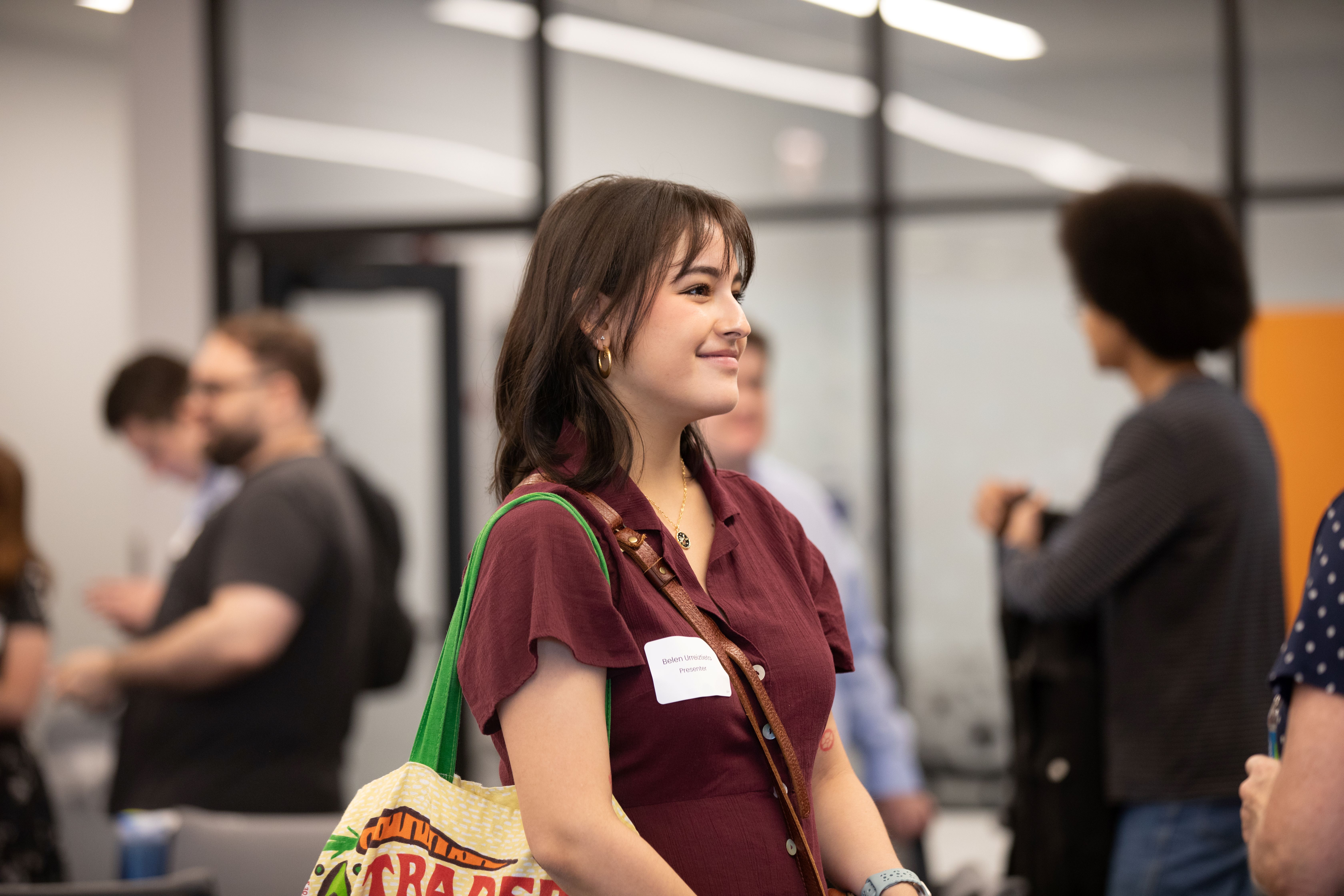 undergraduate student smiles while facing to the right