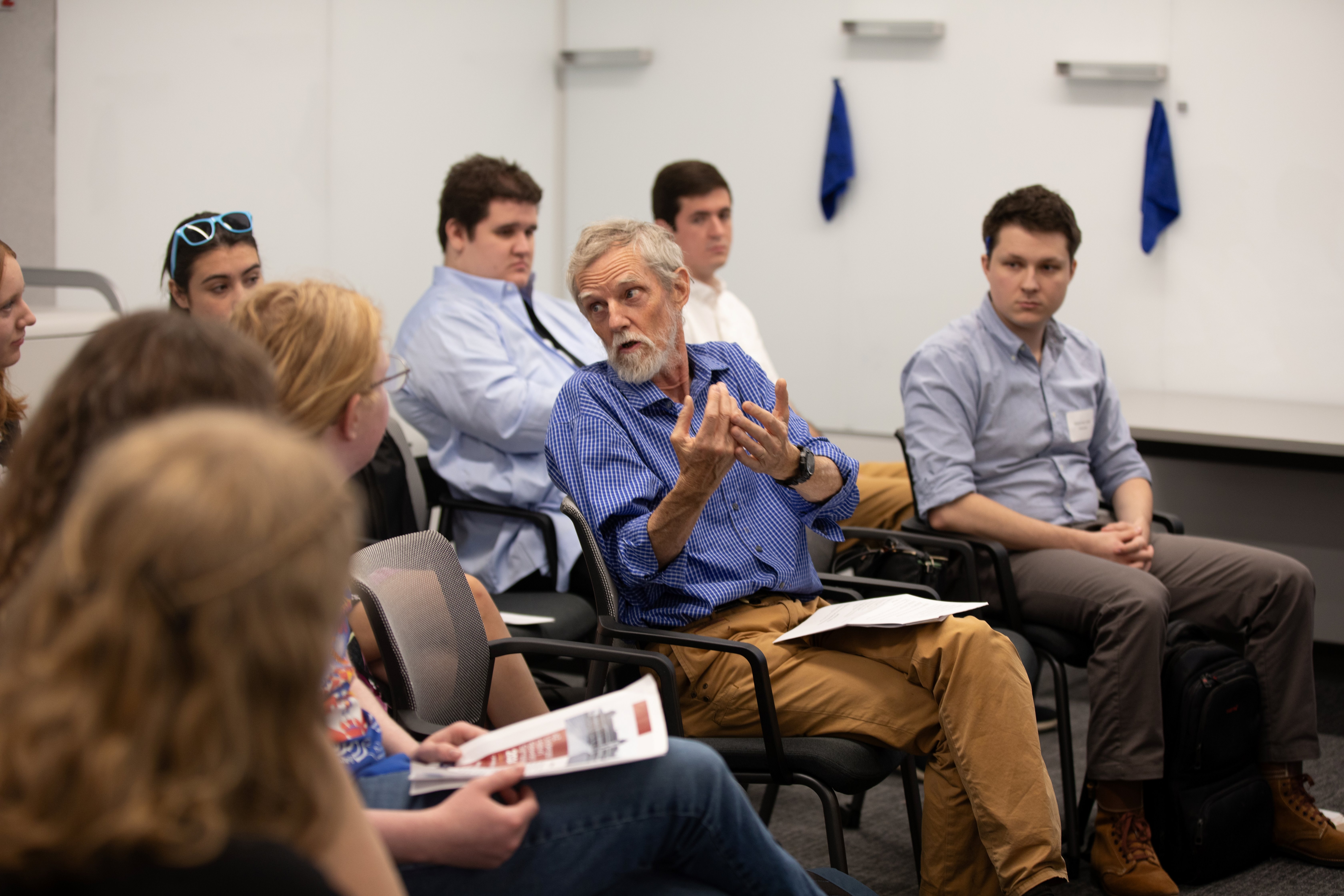 professor engages intently with undergraduate students