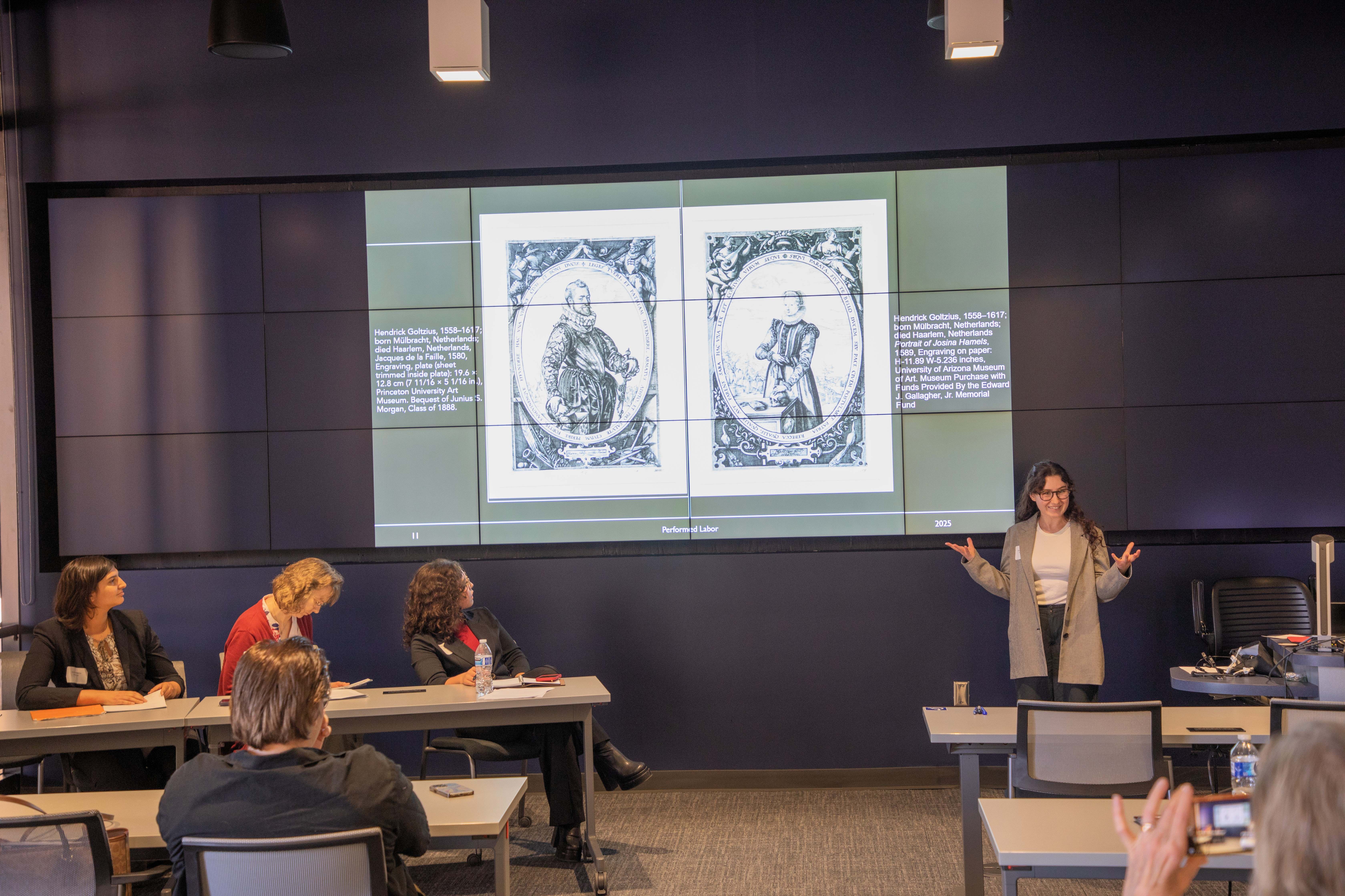 student presents as faculty and student panelists listen