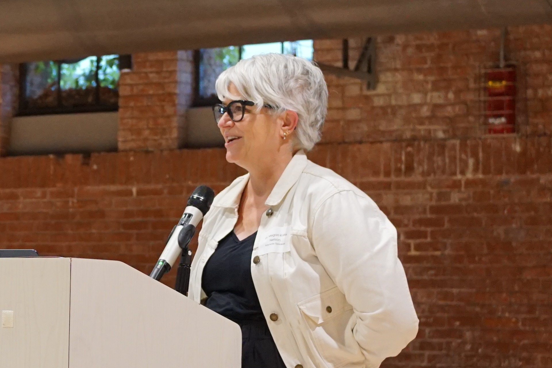 Dr. Megan Kate Nelson speaking at a podium