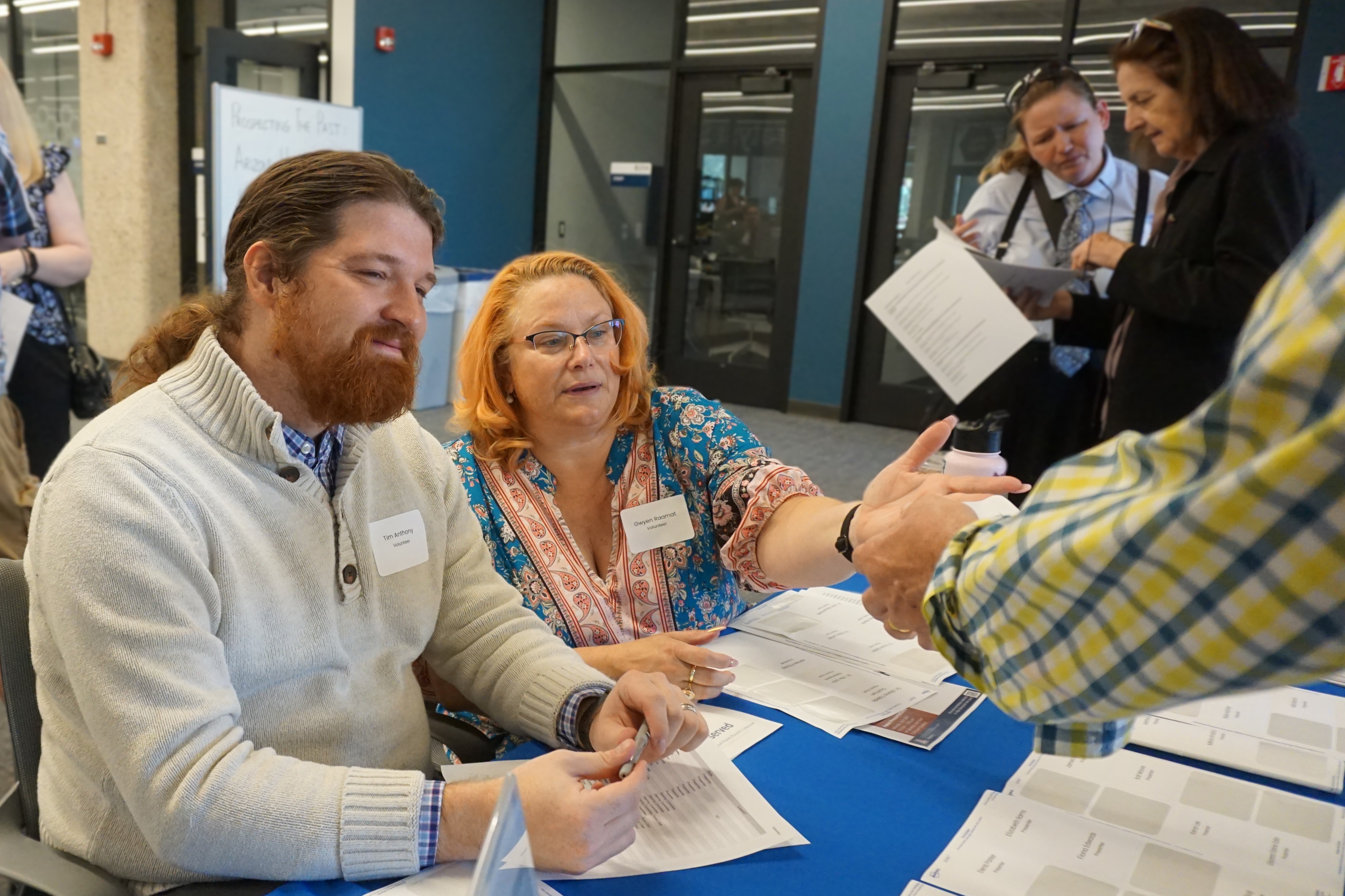 Grad students at working at registration table