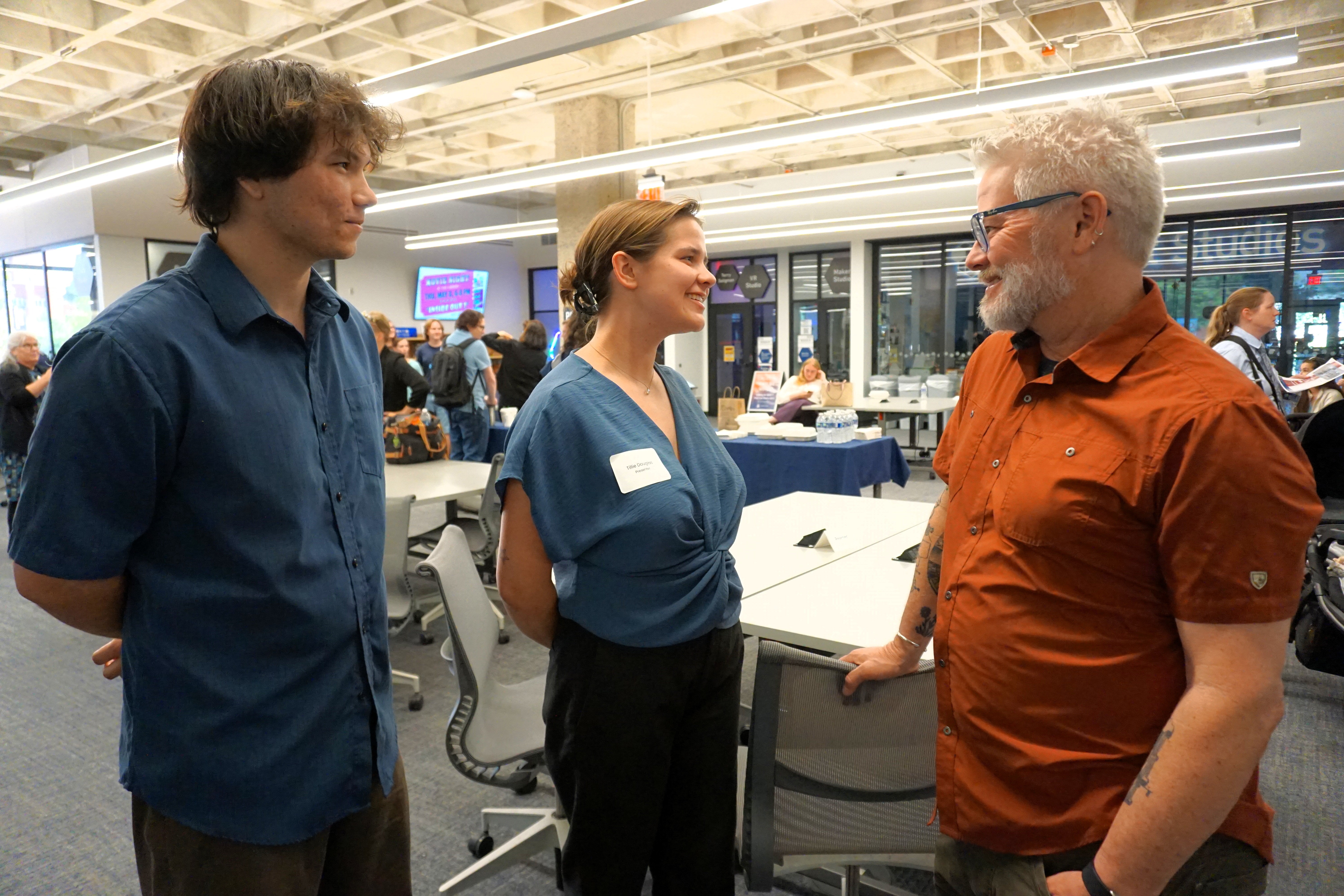 students speaking with a professor