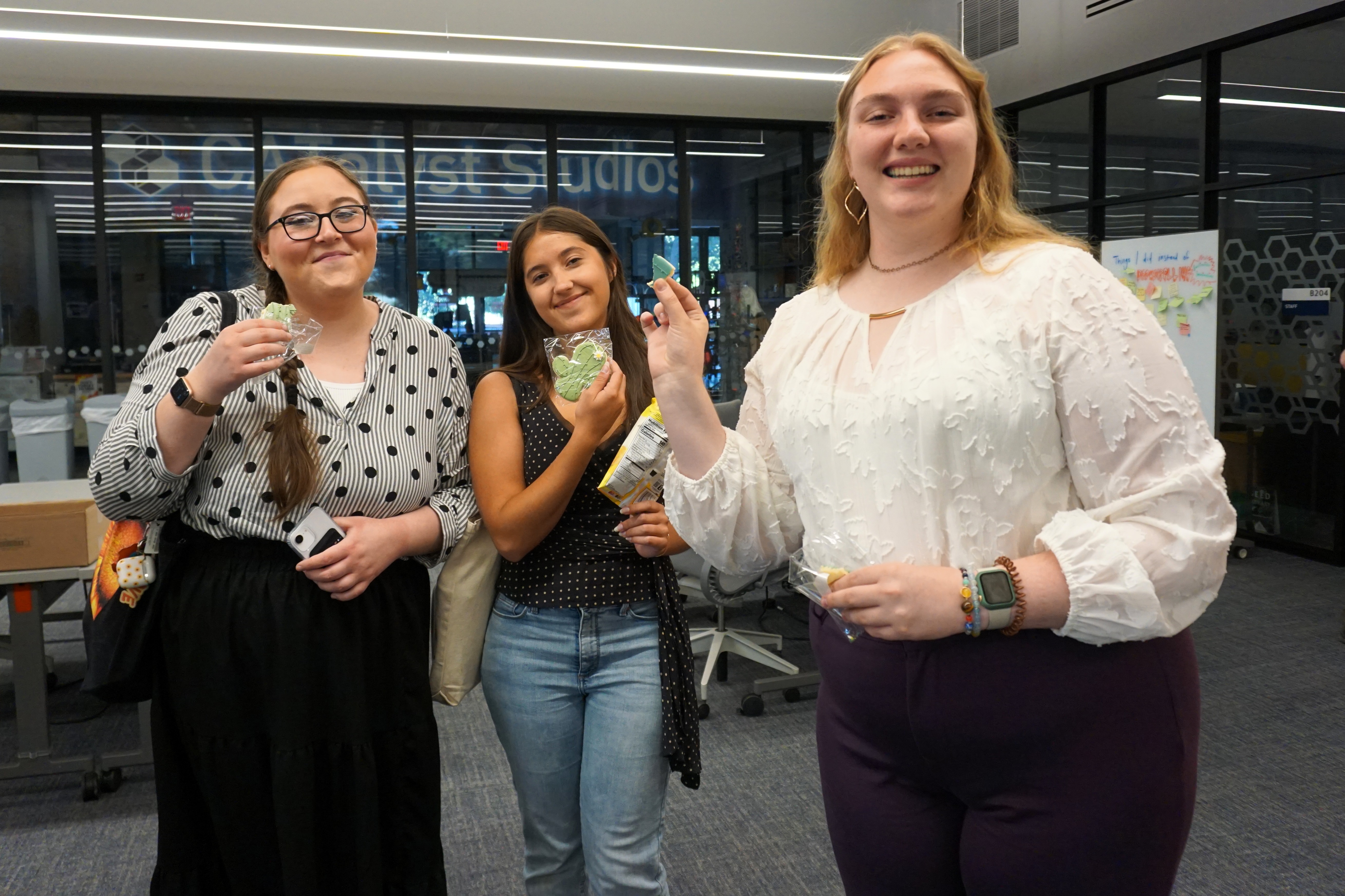 students holding up cookies