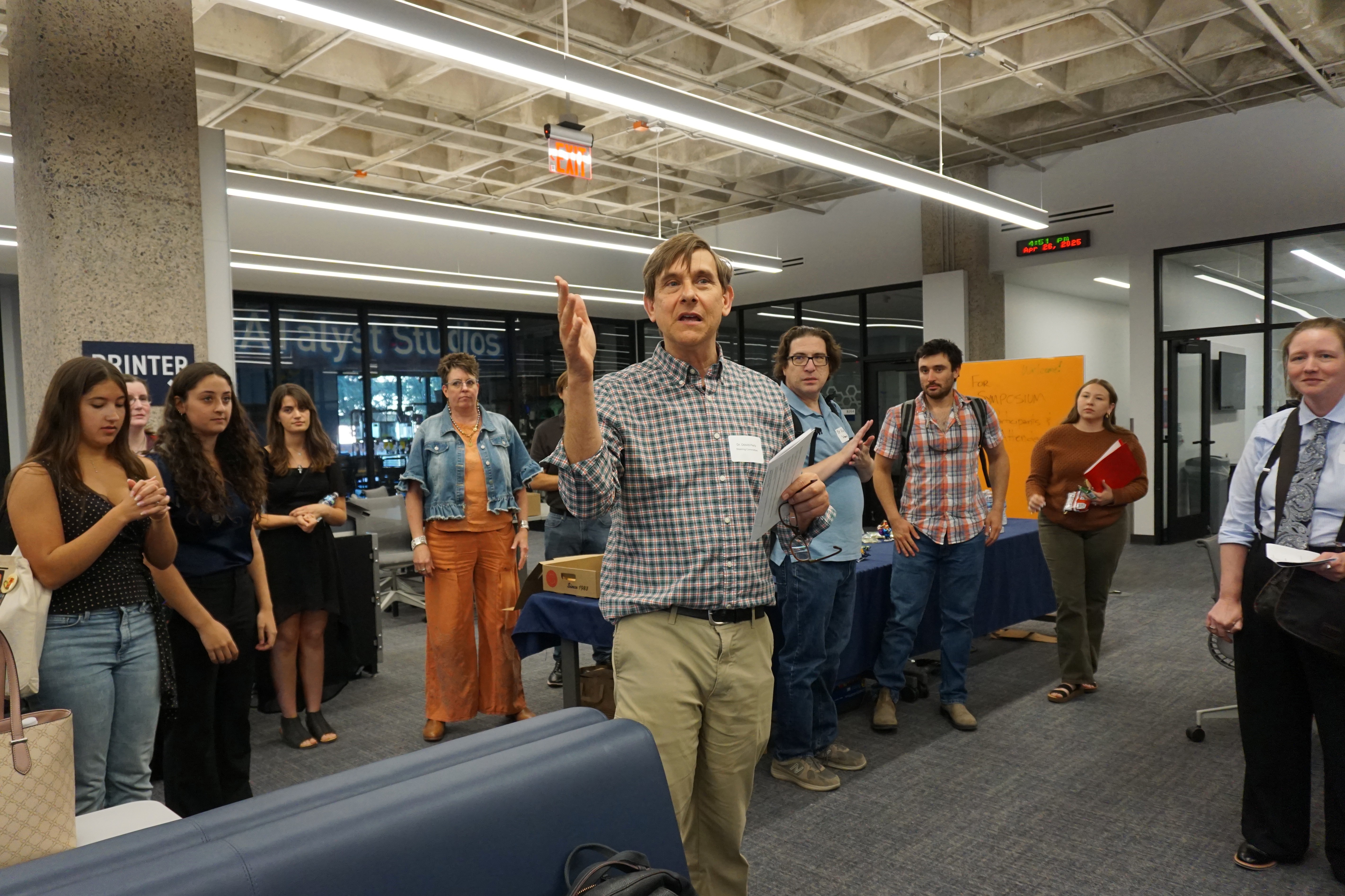professor speaking as people watch